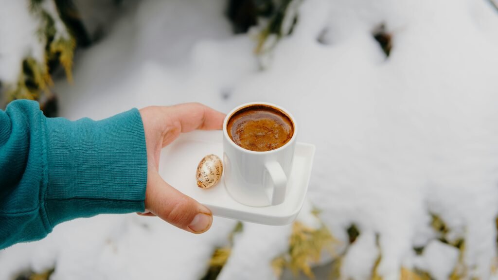 a hand holding a cup full of tea