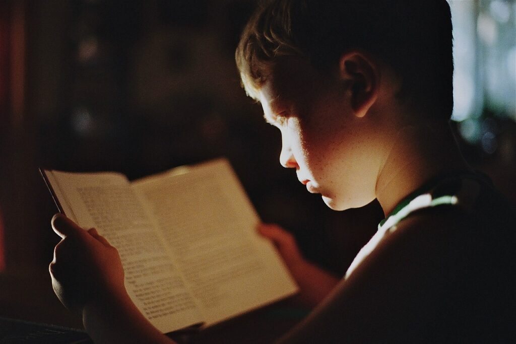 The boy is reading a book a